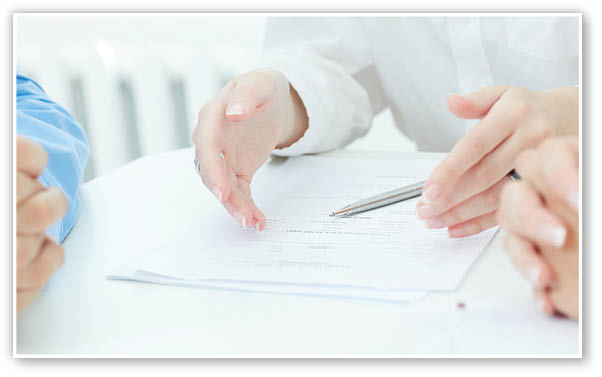 Young doctor explains how to fill out a medical form  Partnership  trust and medical ethics concept