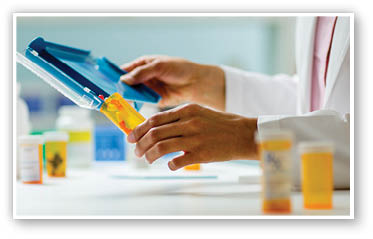 Close Up of pharmacist filling prescription 